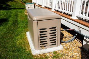 Residential standby generator on concrete slab located outside of home