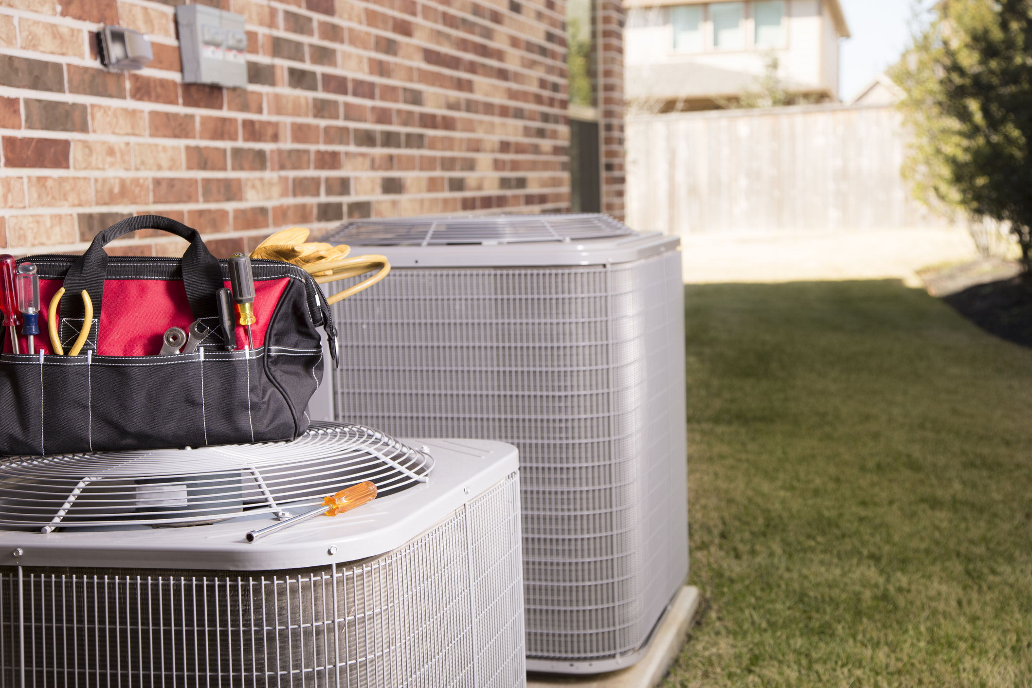 Technician's Equipment Bag Next to HVAC Unit Outside